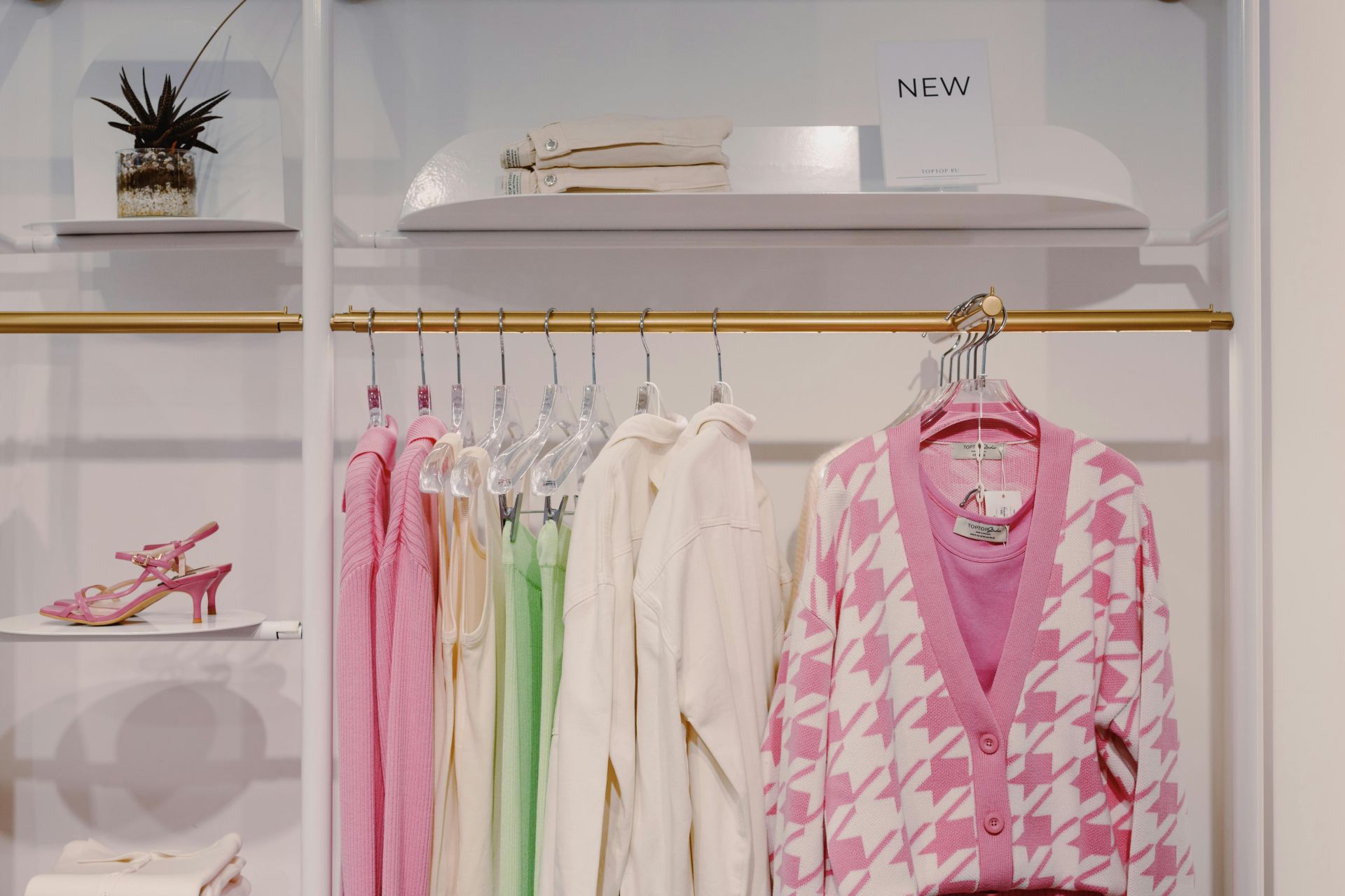 Pink cardigans hanging in a shop