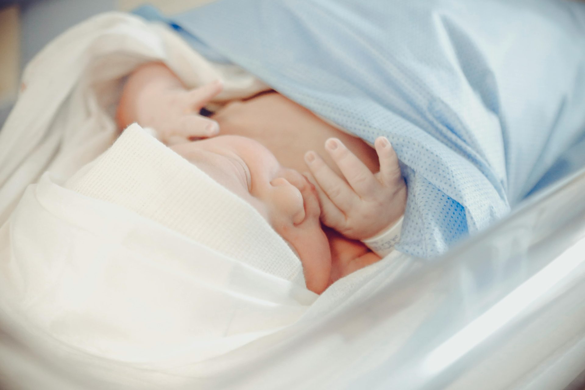 A baby wrapped in a hospital blanket